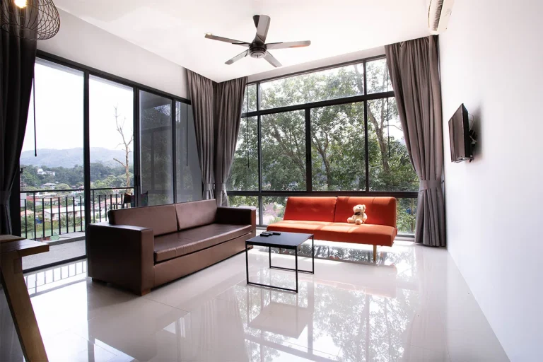 Wohnzimmer in Icon Park mit Sofas und großen Fenstern