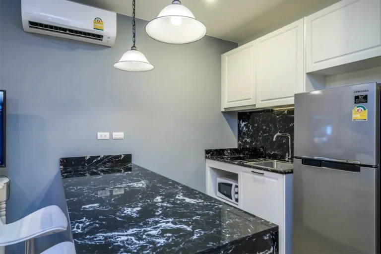 Kitchenette at Palmyrah Surin with a black marble counter