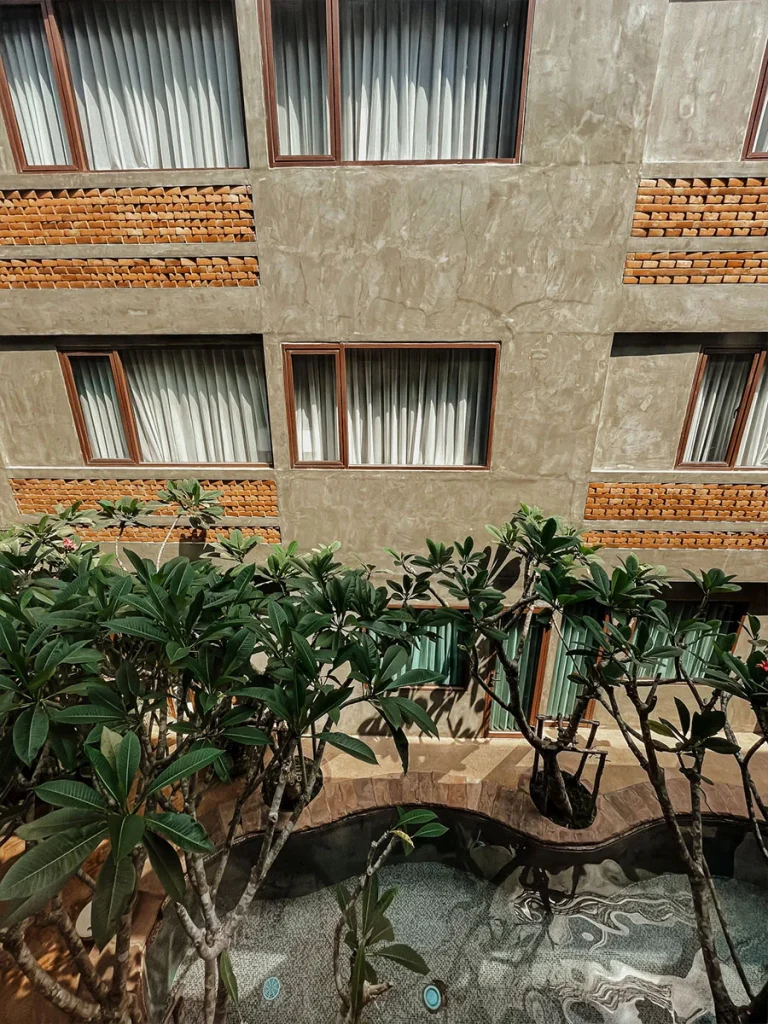 Pool in the courtyard of Norn Nimman13 with frangipani trees