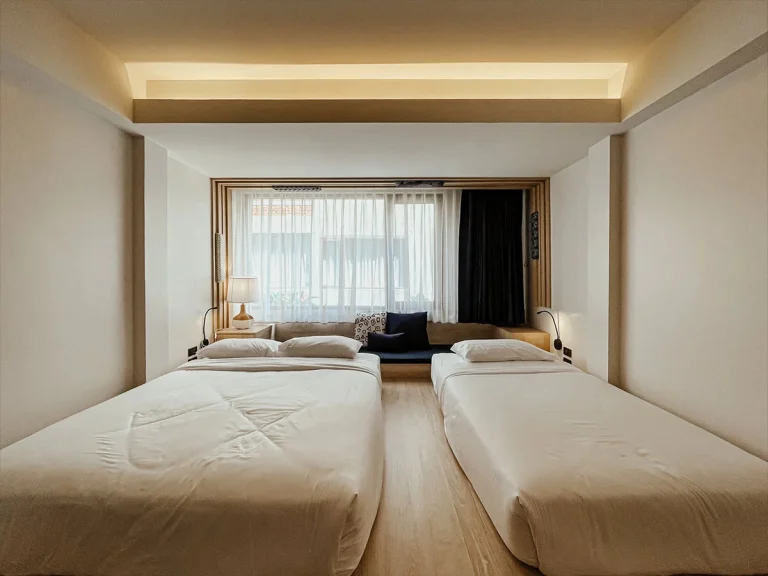 Guest room at Norn Nimman13 with two beds and a wide window