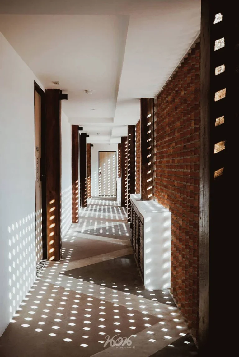 Corridor at Norn Nimman13 with daylight through the brick screen