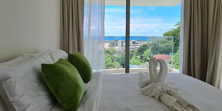 Bedroom at Ocean Town Kata with a view towards the sea