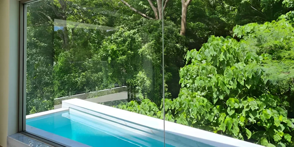Private pool with a glass edge among the trees at Ocean Town Kata
