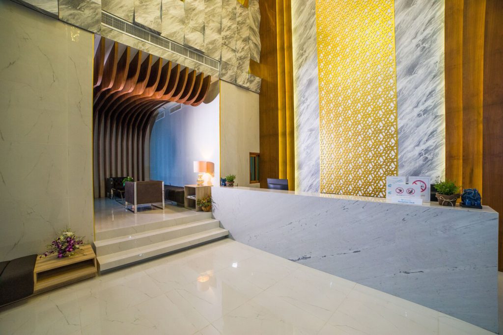 Reception of Oceana Resort with a gold and marble wall