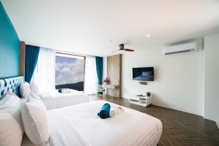 Guest room at Oceana Resort with a double bed and a TV