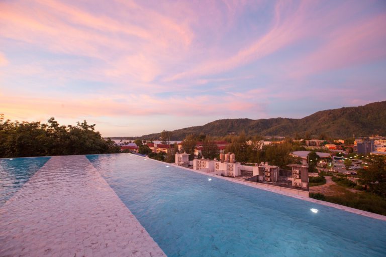 Infinity pool at Oceana Resort at sunset with the Kamala hills
