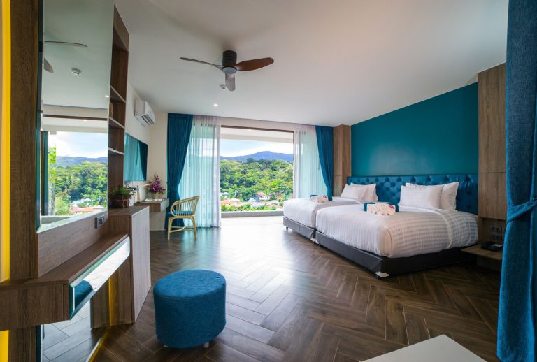 Guest room at Oceana Resort with two beds and a dressing table