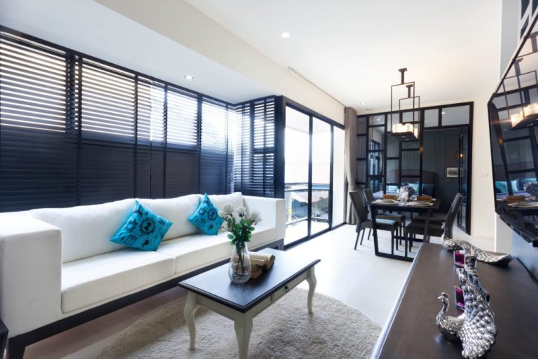 Living room at Palmyrah Surin with a white sofa and a dining area