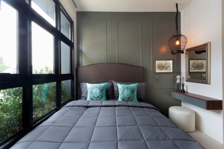 Bedroom at Palmyrah Surin with a double bed by large windows